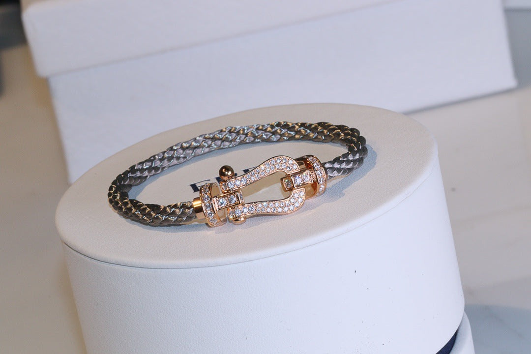 Force 10 bracelet 18k yellow gold and diamonds medium modeland rose gold accents on a white stand