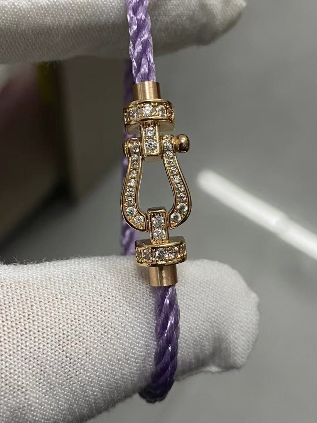 Force 10 bracelet 18k yellow gold and diamonds medium modelbracelet with a gold clasp on a white glove