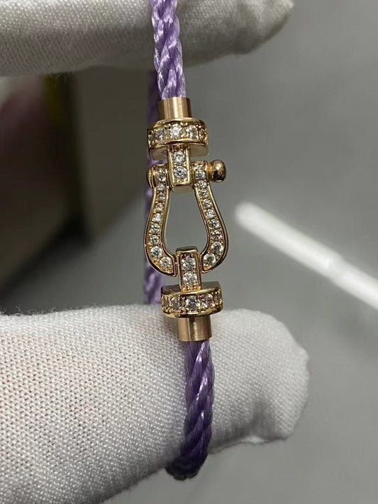Force 10 bracelet 18k yellow gold and diamonds medium modelbracelet with a gold clasp on a white glove