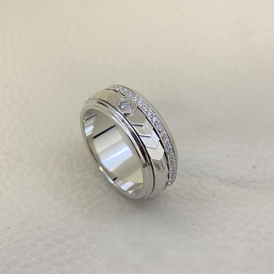 “Fortune Flow 925 sterling silver spinning ring with pavé zircons flat lay” Silver ring with intricate design on a light gray background