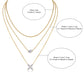 Clean white background — the four-leaf clover moissanite pendant layered with 2-3 mixed chains on a bust form. The clover catches light from multiple angles, showcasing sparkling moissanite accents on each leaf. Chains drape smoothly at balanced lengths.