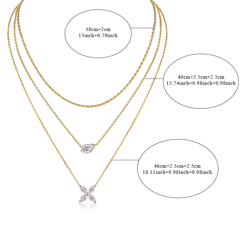 Clean white background — the four-leaf clover moissanite pendant layered with 2-3 mixed chains on a bust form. The clover catches light from multiple angles, showcasing sparkling moissanite accents on each leaf. Chains drape smoothly at balanced lengths.