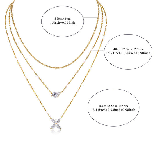 Clean white background — the four-leaf clover moissanite pendant layered with 2-3 mixed chains on a bust form. The clover catches light from multiple angles, showcasing sparkling moissanite accents on each leaf. Chains drape smoothly at balanced lengths.