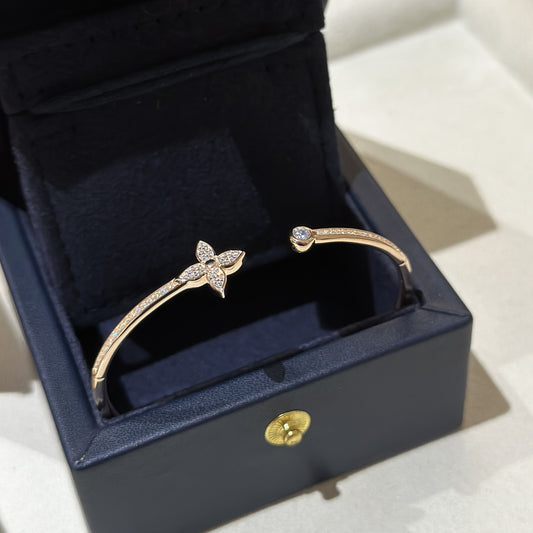 Gold bracelet with a butterfly design in a black jewelry box