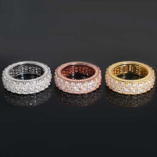 Gold eternity band on dark background, showing continuous pavé sparkle. Alt: “Full-Pavé Moissanite Eternity Ring – 18K Gold Unisex.”