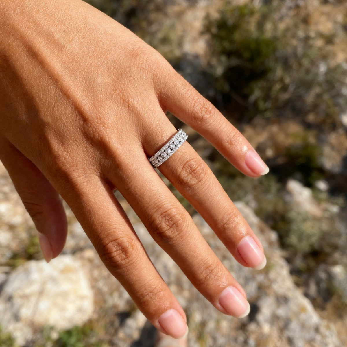 Continuous moissanite stones on band with matching center halo.