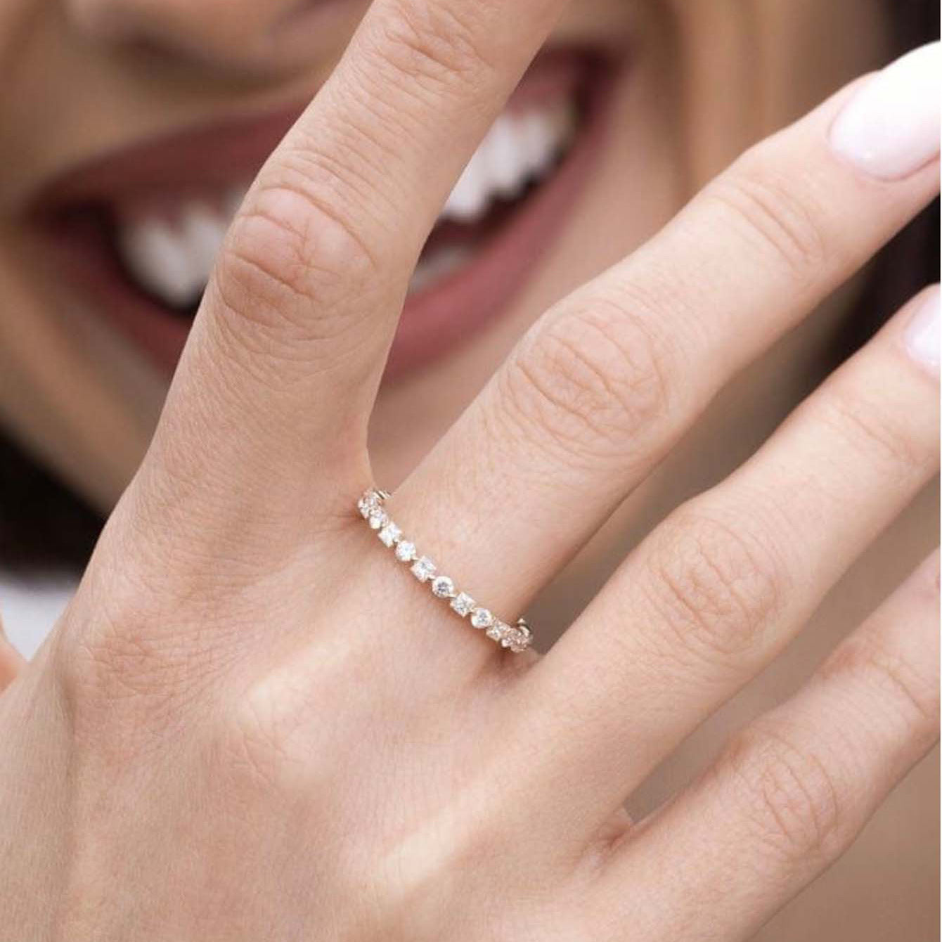 Ring worn alone as elegant band. Alt: “Continuous Sparkle: Moissanite Eternity Ring.”