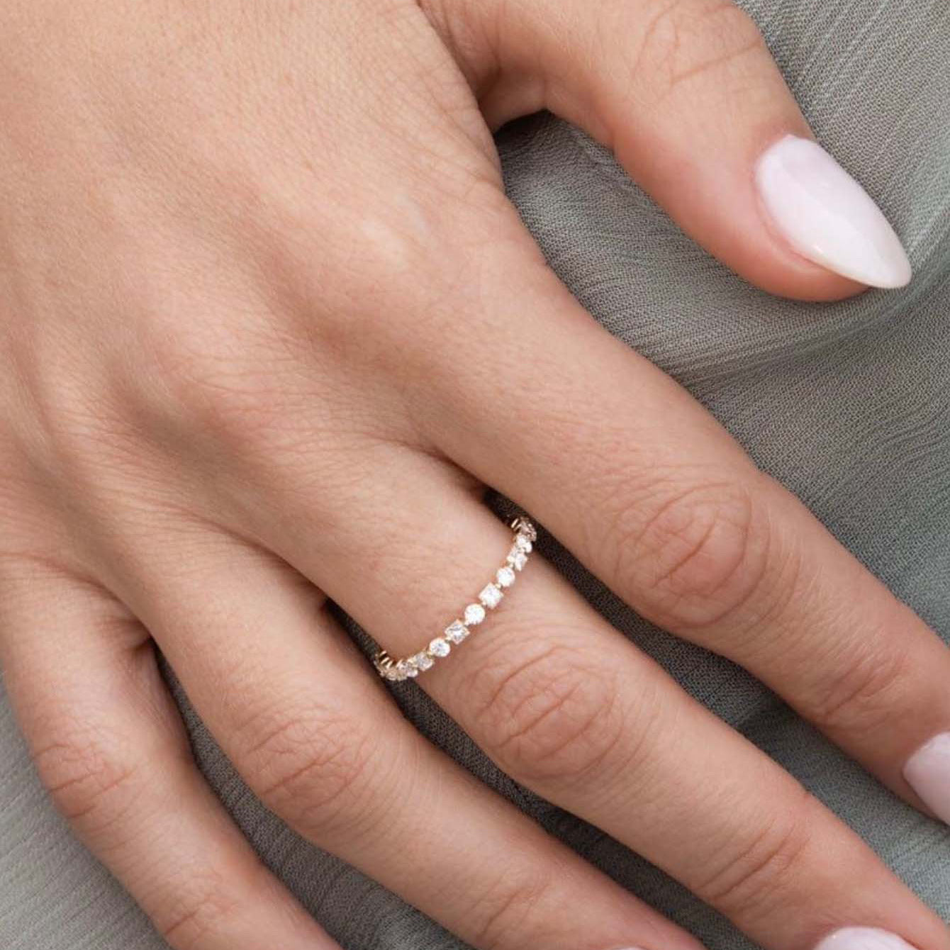 Ring worn alone as elegant band. Alt: “Continuous Sparkle: Moissanite Eternity Ring.”