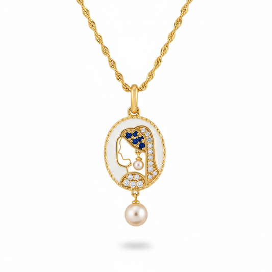 Gold necklace with a pendant featuring a face, blue eyes, and a pearl on a white background