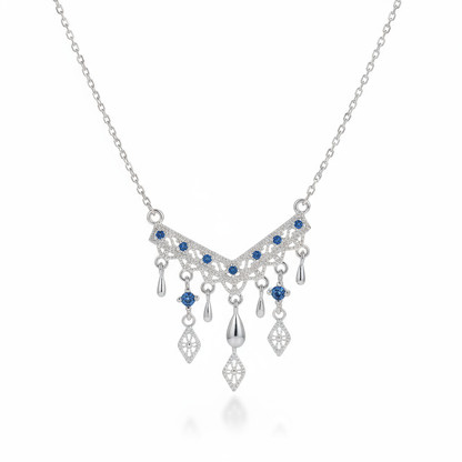 Silver necklace with blue gemstones on a white background