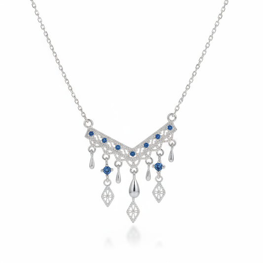 Silver necklace with blue gemstones on a white background