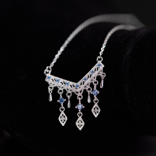 Silver necklace with blue stones on a black background