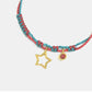 Colorful braided bracelet with star and heart charms on a white background