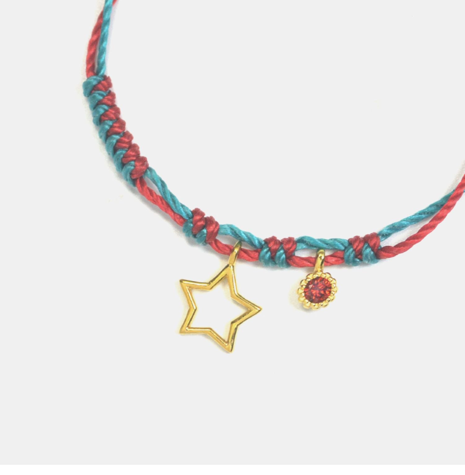 Colorful braided bracelet with star and heart charms on a white background