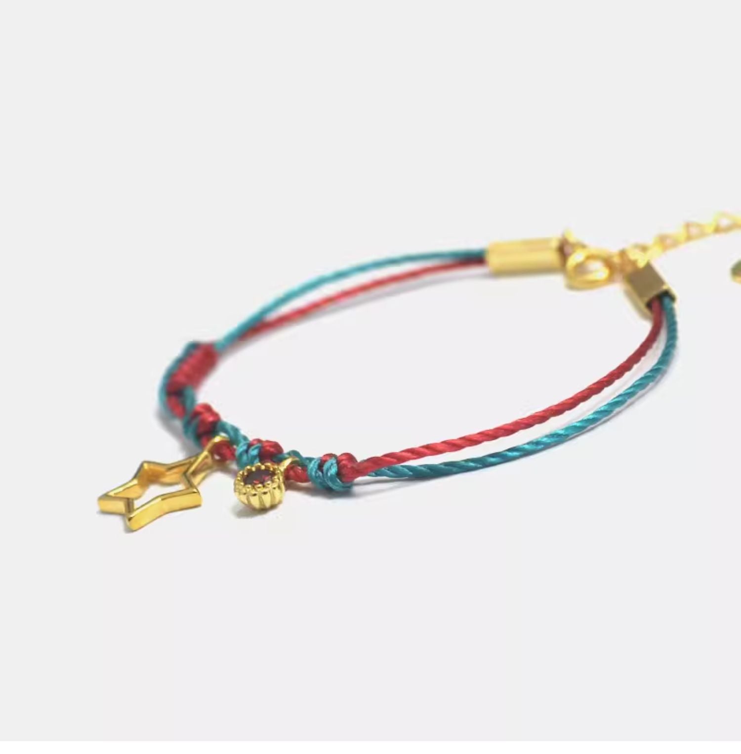  This Gold-Plated Sterling Silver Star Bracelet combines vibrant red and green braided cords with a finely crafted five-pointed star charm.