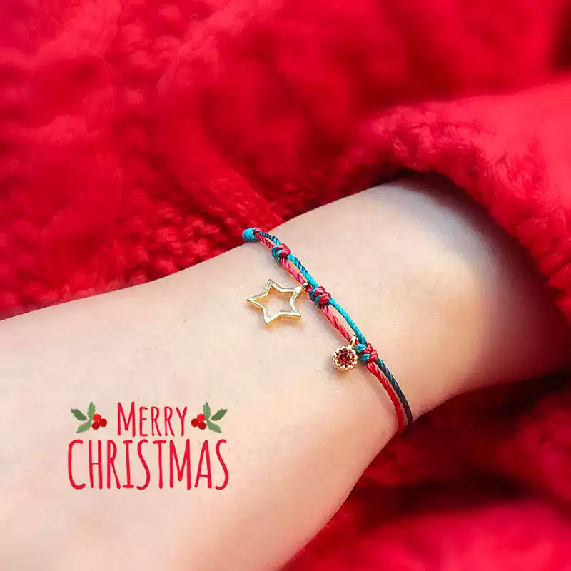 Ankle bracelet with star charm on a red background, featuring 'Merry Christmas' text.