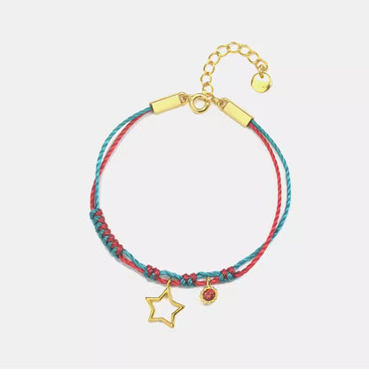  This Gold-Plated Sterling Silver Star Bracelet combines vibrant red and green braided cords with a finely crafted five-pointed star charm.