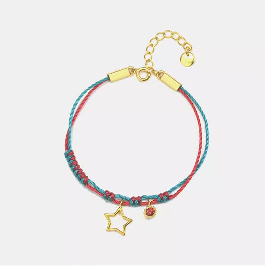  This Gold-Plated Sterling Silver Star Bracelet combines vibrant red and green braided cords with a finely crafted five-pointed star charm.