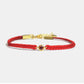 Red bracelet with a gold clasp on a white background