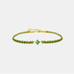 Green and gold bracelet with a central gemstone on a light gray background