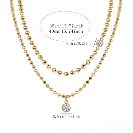 High-definition shot of both necklaces laid flat together on pure white background, arranged to show the layered effect.