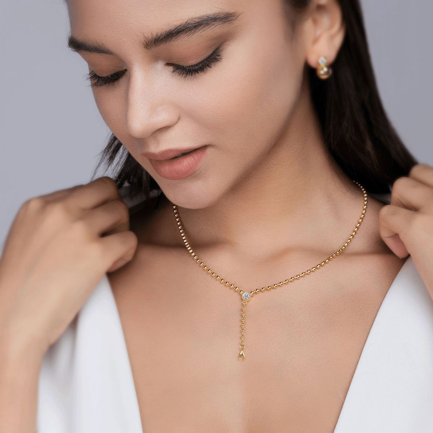 Model wearing the necklace alone on bare skin.