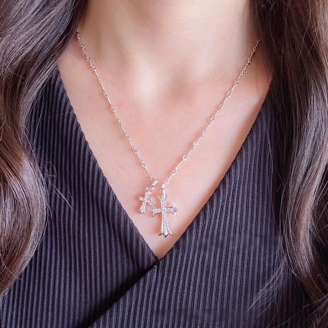 “Female model wearing gold and silver double cross necklace choker style”