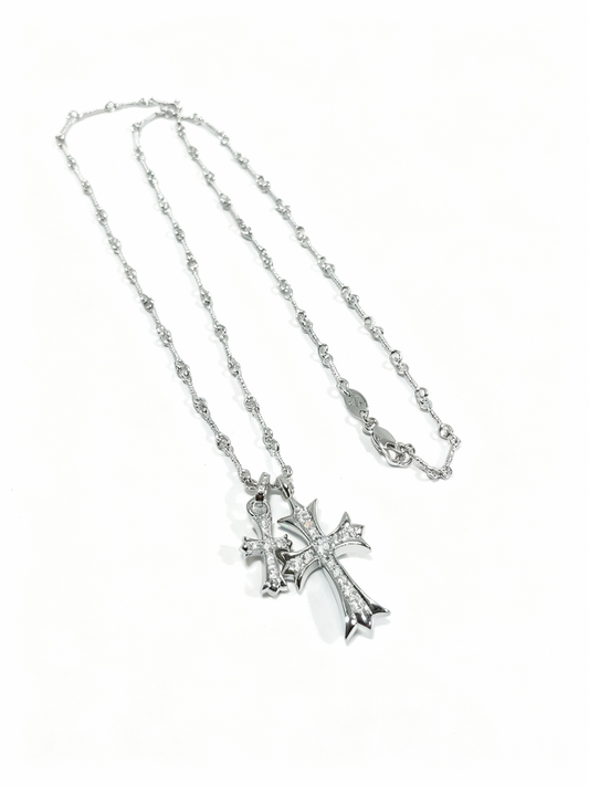 “Gold and silver double cross necklace flat lay showing zircon pendant and link chain”