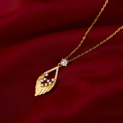 Necklace with blue and white beads and a gold pendant on a gold background
