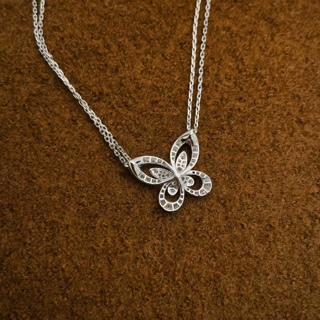Graff butterfly diamond pendant on white background”