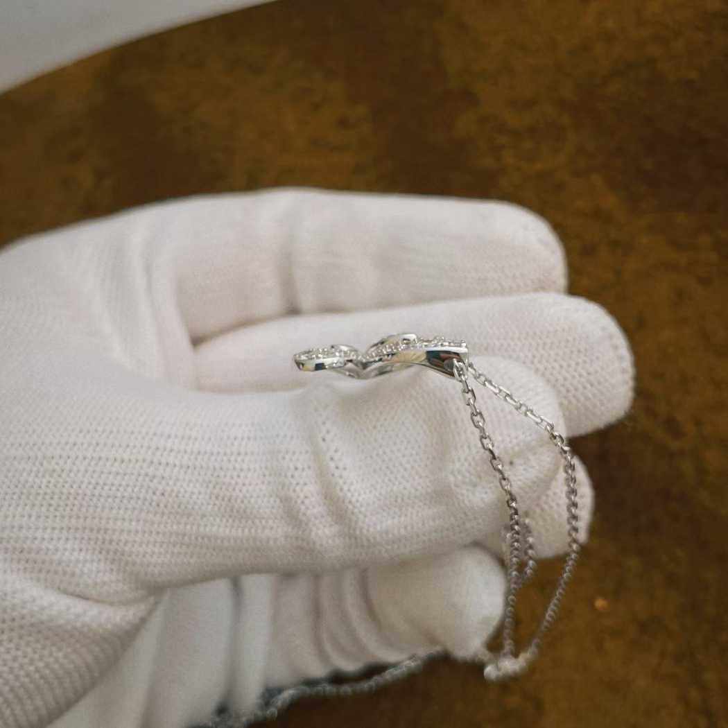 “Close-up of butterfly silhouette diamond setting Graff pendant”