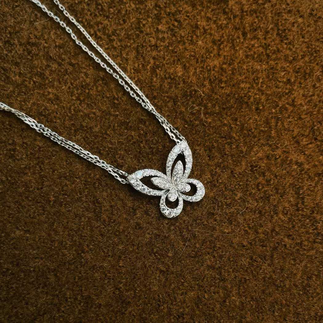 “Graff Butterfly Silhouette large diamond pendant necklace flat lay”