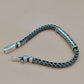 Silver braided bracelet on a beige background