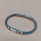 Silver braided bracelet on a beige background