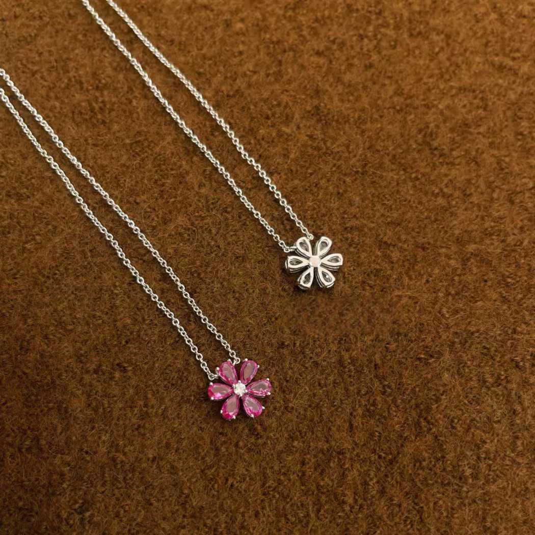 Harry Winston floral diamond pendant on white background”