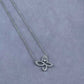 “Harry Winston Infinite Lily Cluster diamond pendant necklace flat lay”