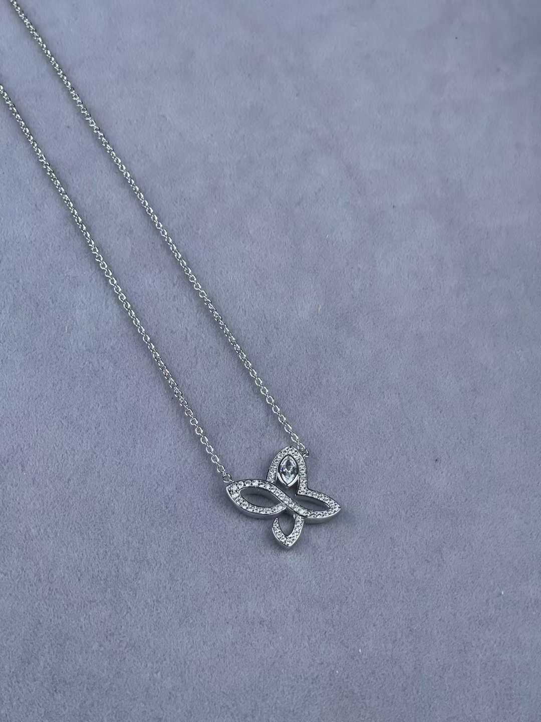 “Harry Winston Infinite Lily Cluster diamond pendant necklace flat lay”