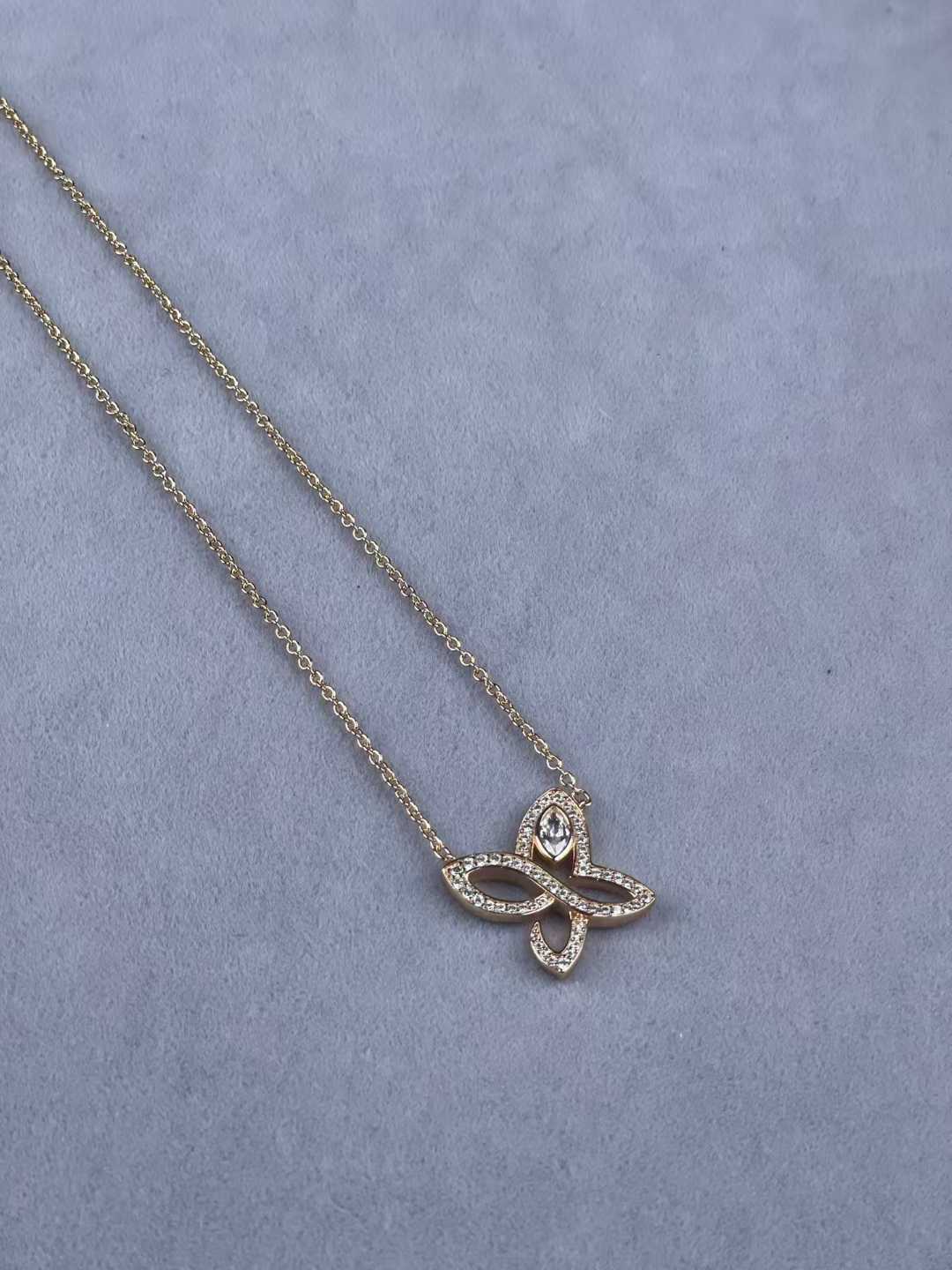 “Harry Winston Infinite Lily Cluster diamond pendant necklace flat lay”