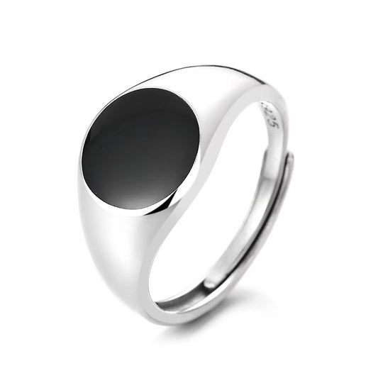 Silver ring with a black stone on a white background
