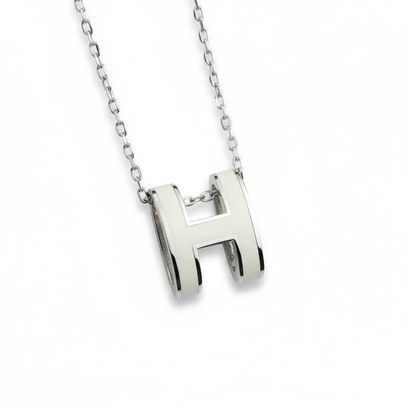 High-End “H” Enamel Pendant Necklace Silver necklace with a 'H' pendant on a white background