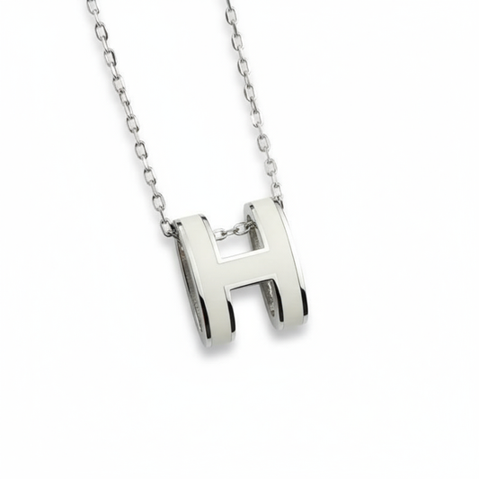 High-End “H” Enamel Pendant Necklace Silver necklace with a 'H' pendant on a white background