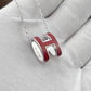 High-End “H” Enamel Pendant Necklace Silver and red 'H' pendant necklace on a light gray background