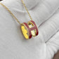 High-End “H” Enamel Pendant Necklace Gold and red necklace with 'H' design on a light gray background