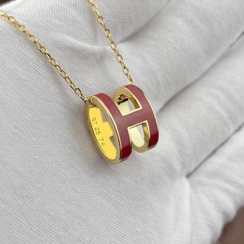 High-End “H” Enamel Pendant Necklace Gold and red necklace with 'H' design on a light gray background