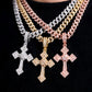 Three gold cross pendants on a black background