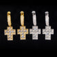 Pair of gold hoop earrings with cross designs on a black background