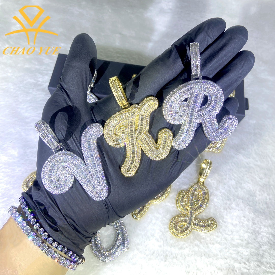 Black gloves with diamond-encrusted letter pendants on a white background