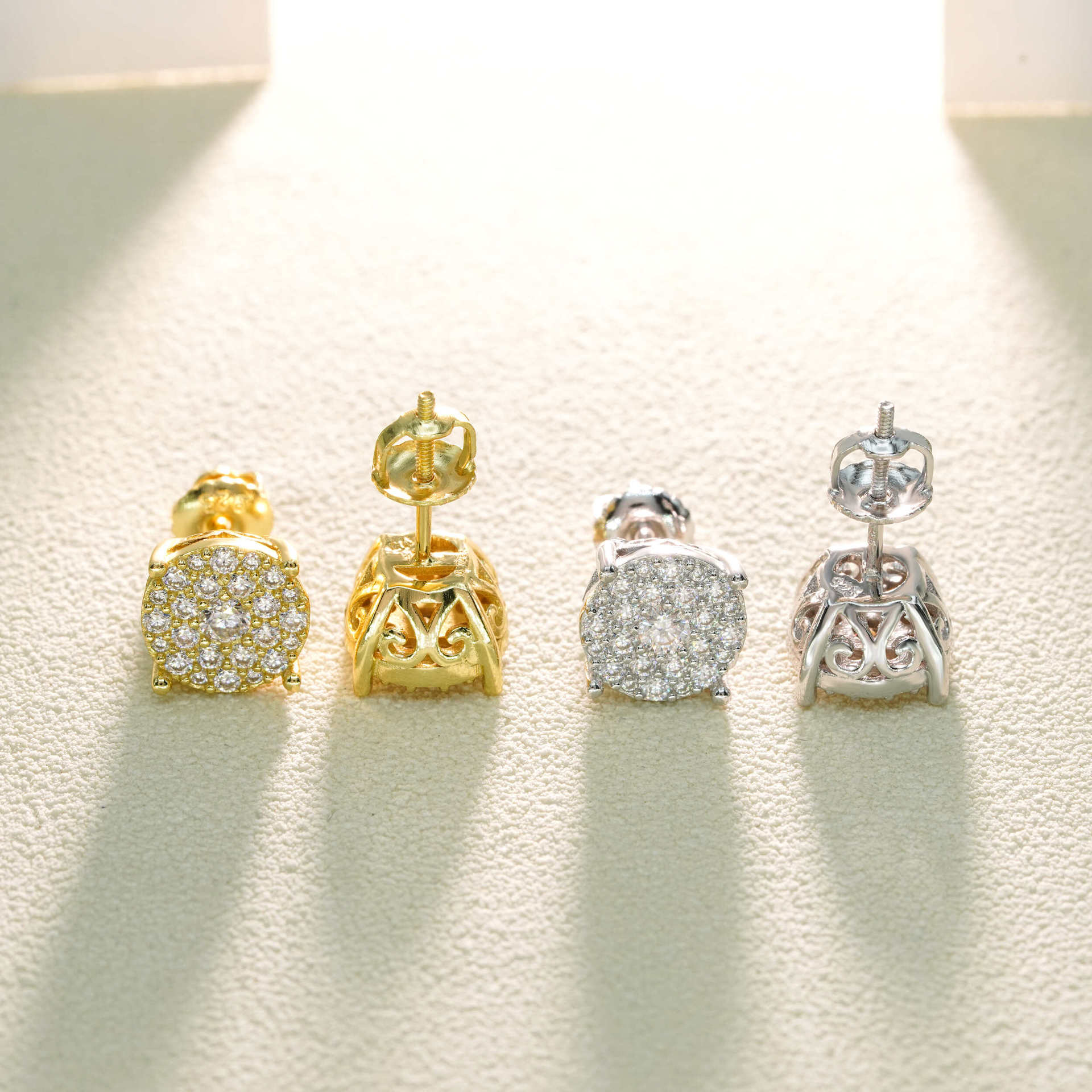 Pair of gold and silver earrings on a light background