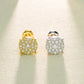 Gold and silver earrings with gemstones on a textured beige background