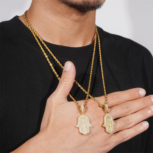 Gold necklaces with Hamsa hand pendants worn by a person